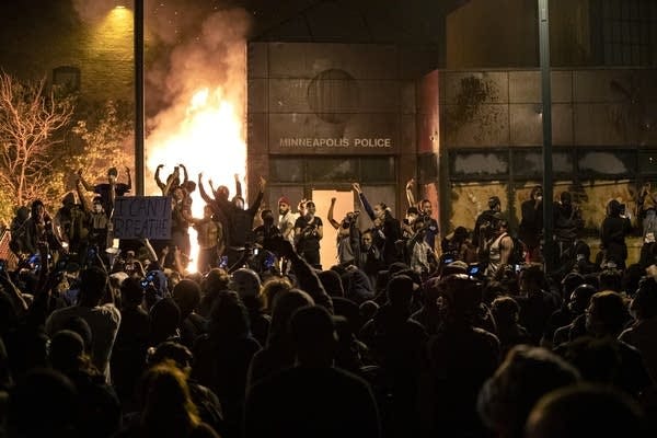 Protesters gesture after the Minneapolis police 3rd Precinct